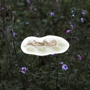 Otter floating through lily pads while reading a book sticker, watercolour sticker, handpainted otter sticker, otter journalling sticker